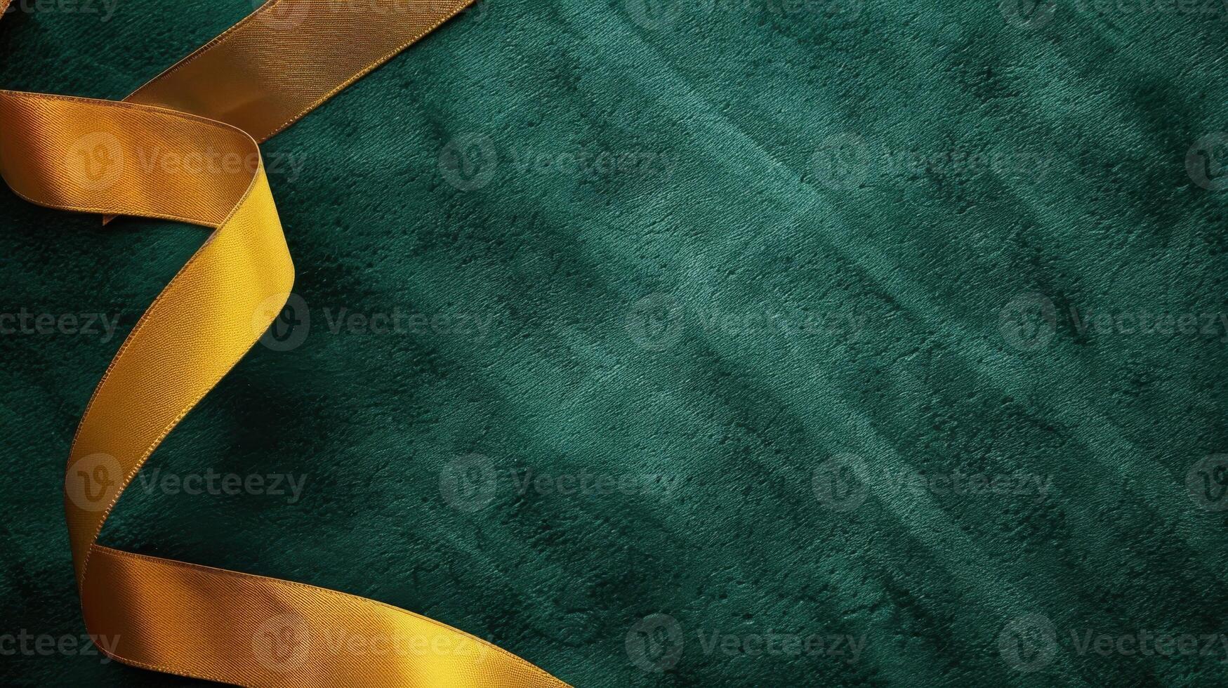 Emerald green velvet texture with a gold ribbon draped diagonally across the surface photo