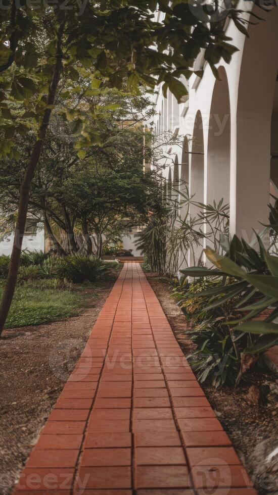 A red brick pathway leads to a building photo