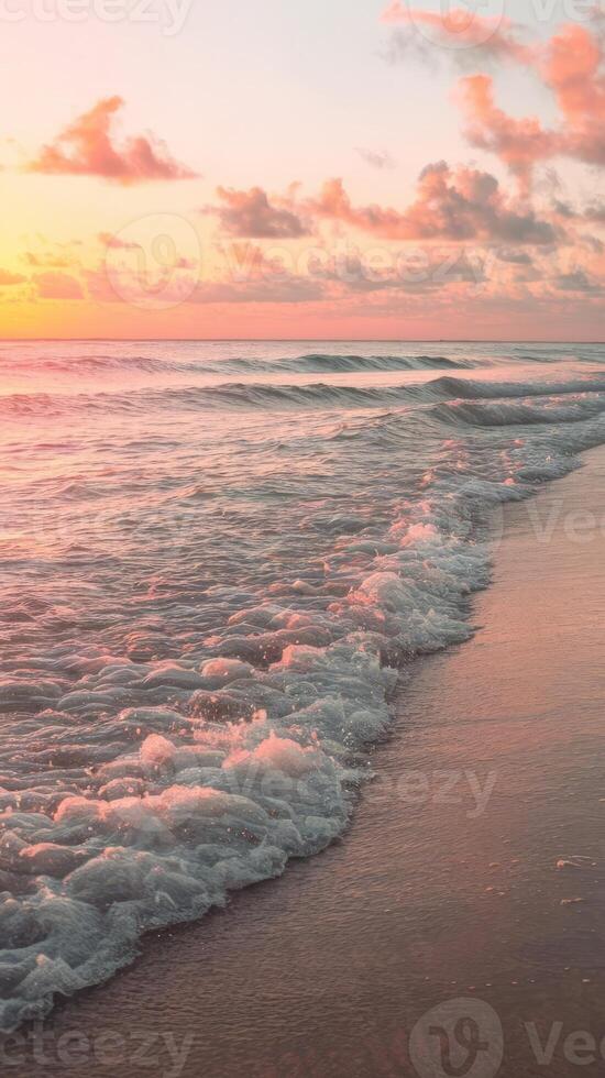 A beautiful sunset on the beach with waves and clouds photo