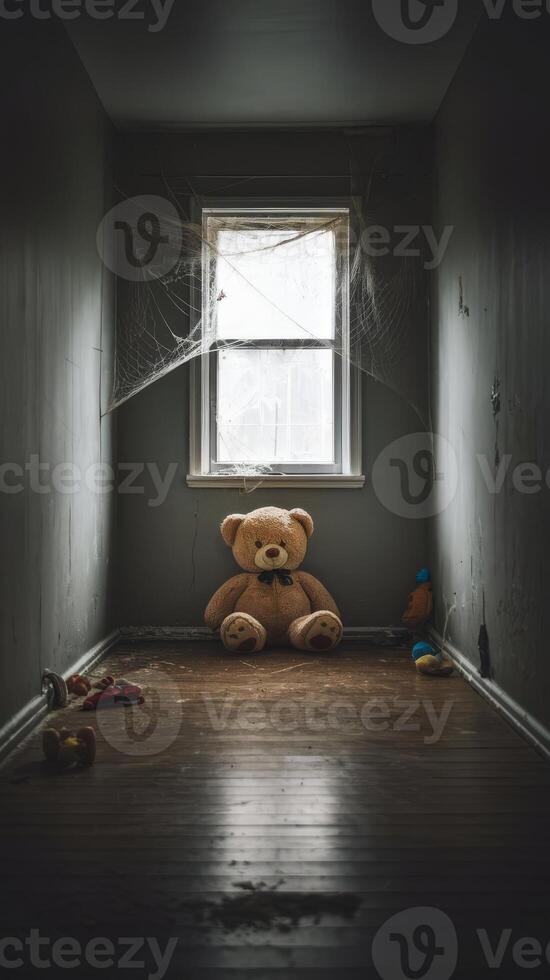 A teddy bear sits in an empty room photo