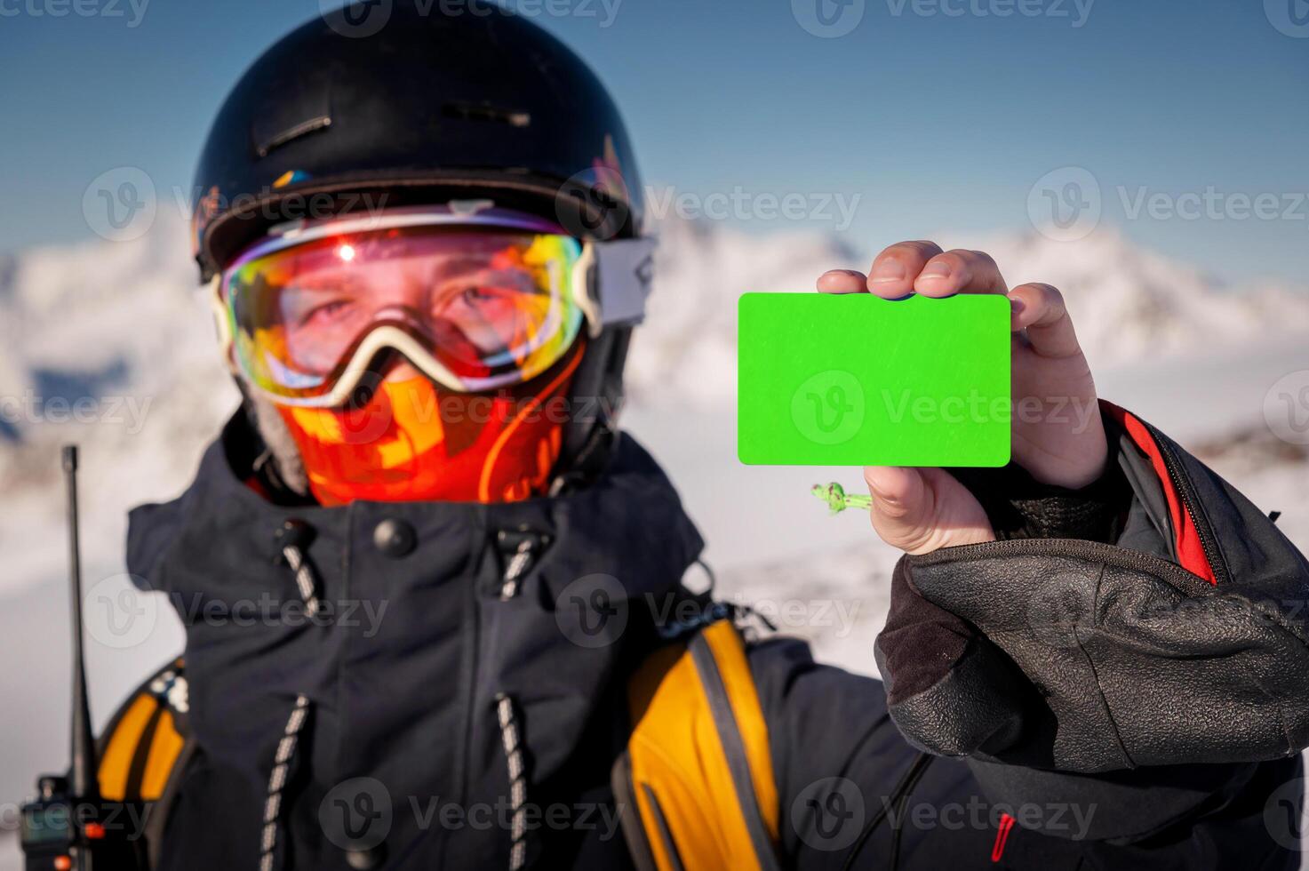 Girl in winter gear holding ski pass and snowboard smiling. Concept for illustration of ski entrance fee, demonstration of qualified instructor certificate at ski resort photo