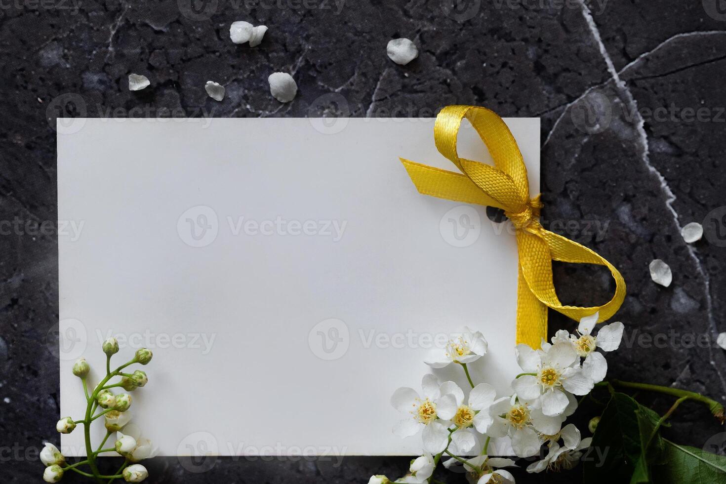 Floral layout on a vintage white wooden background On a sunny dayand computer partially. Spring flowers, woman freelancing concept. View from above. photo