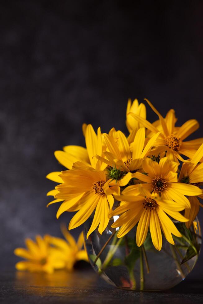 Bouquet of yellow flowers on a dark background in grunge e, act floral arrangement, mother's day, wedding gift,spring or autumn background with a place for text, minimalistic holiday concept, photo
