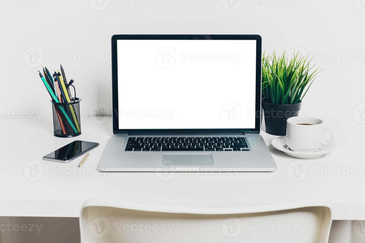 Front view of modern workplace in office with computer and supplies photo