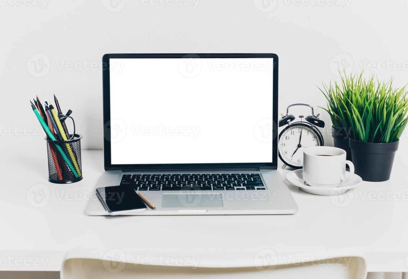 Front view of modern workplace in office with computer and supplies photo