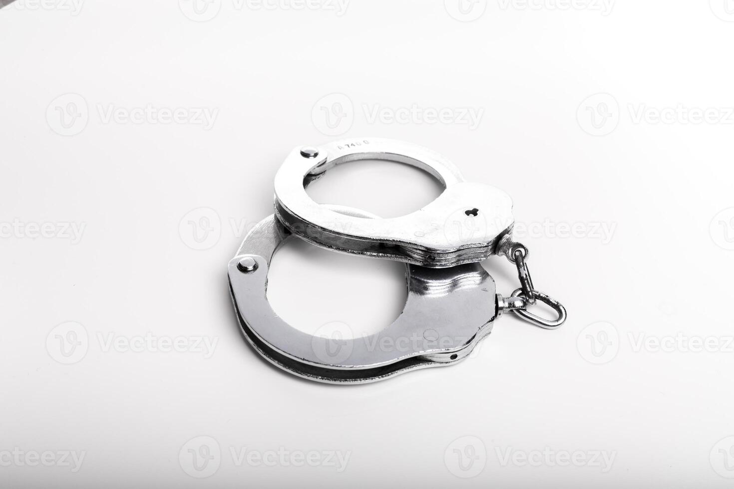 Silver handcuffs close up isolated on white background photo