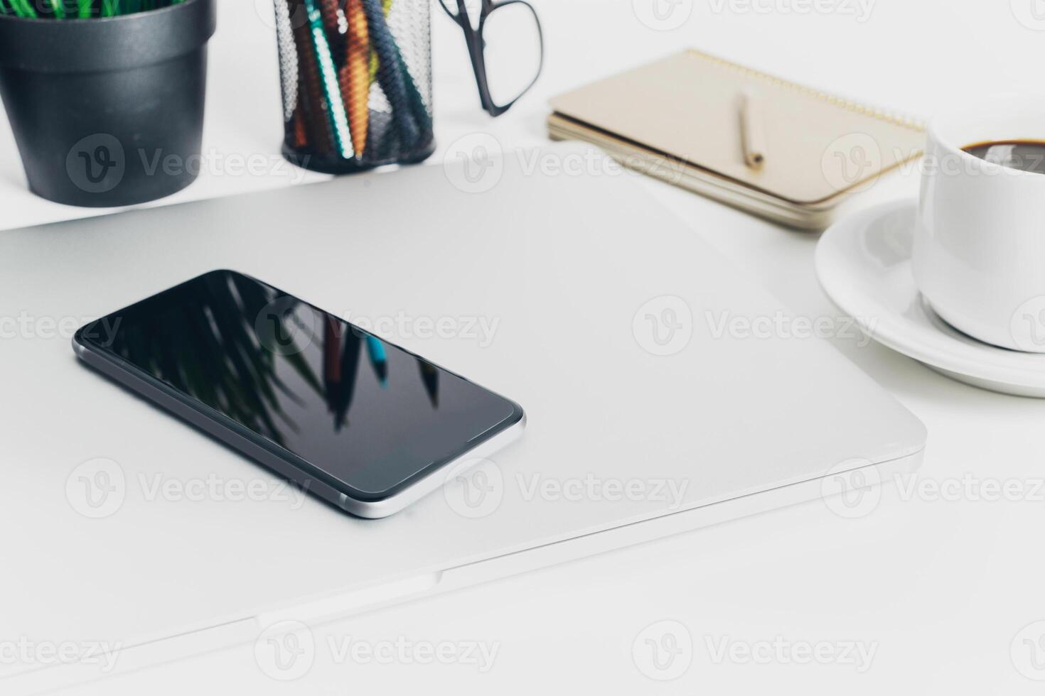 Close up shot of working table with gadget and supplies photo