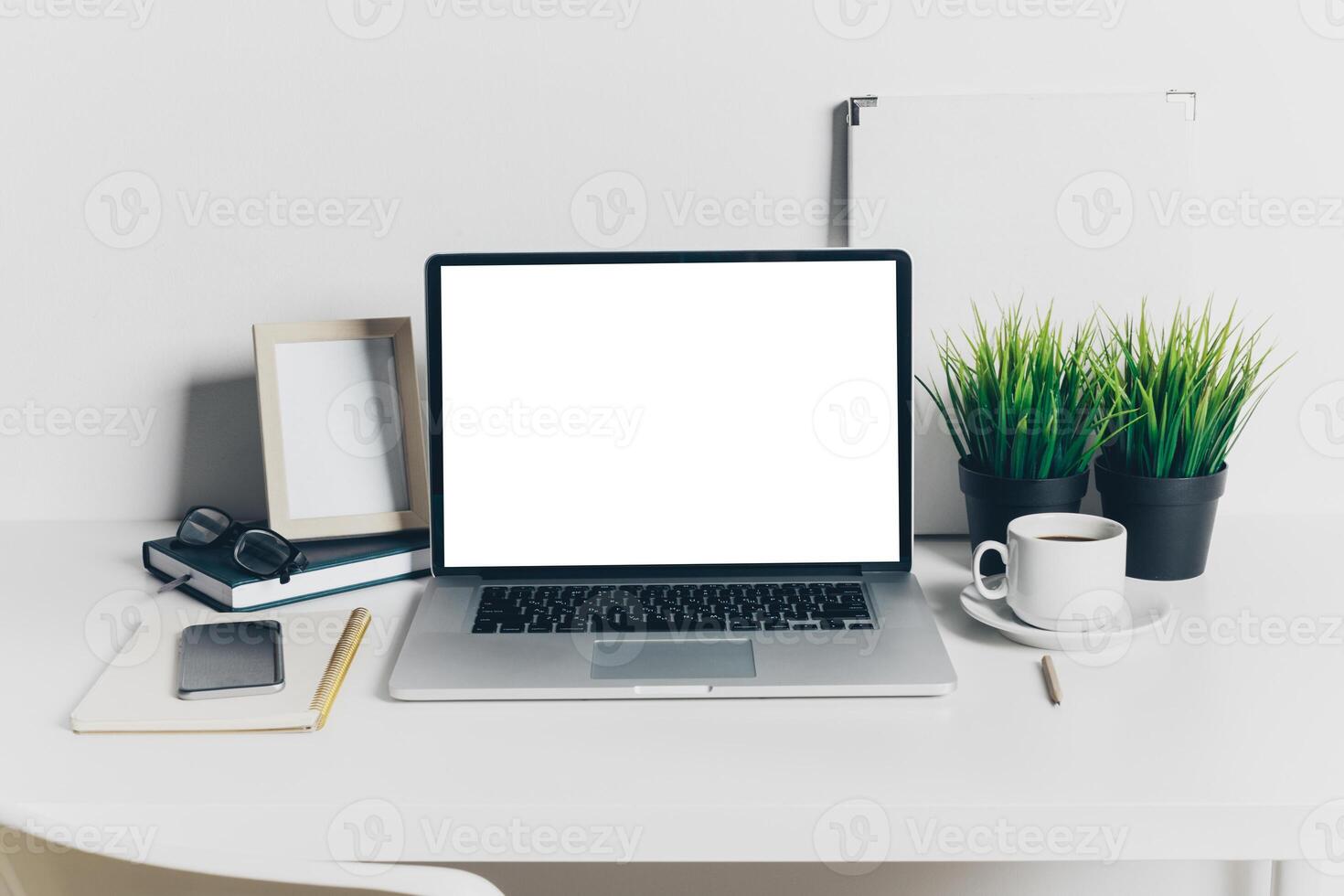 Front view of modern workplace in office with computer and supplies photo