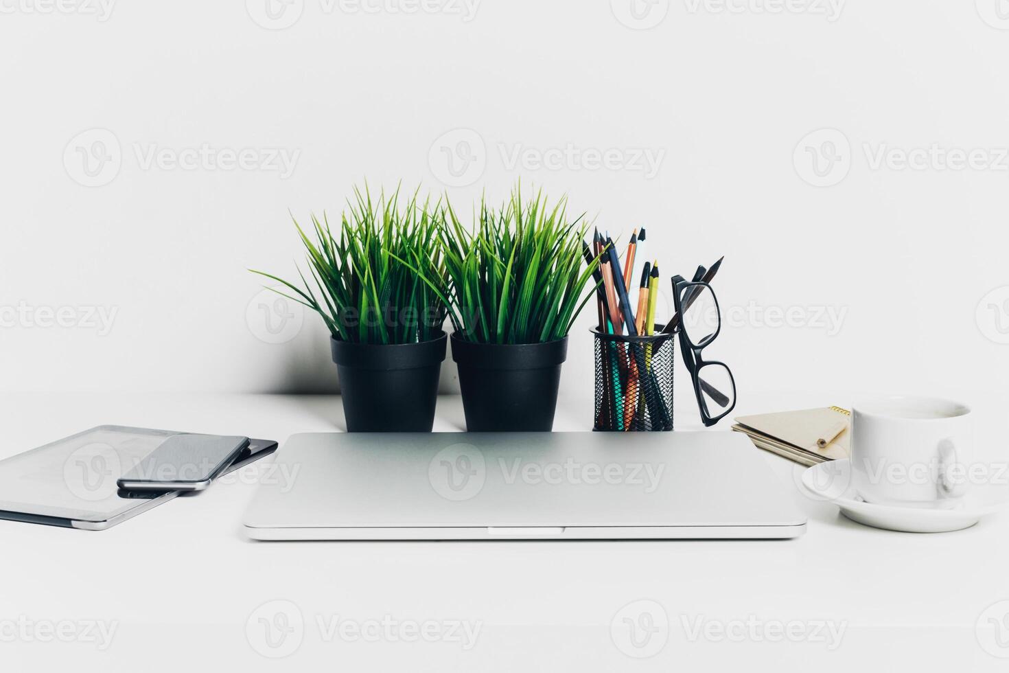 Close up shot of working table with gadget and supplies photo