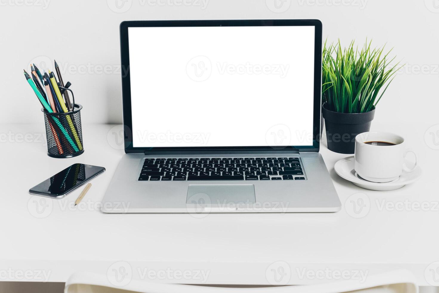 Front view of modern workplace in office with computer and supplies photo