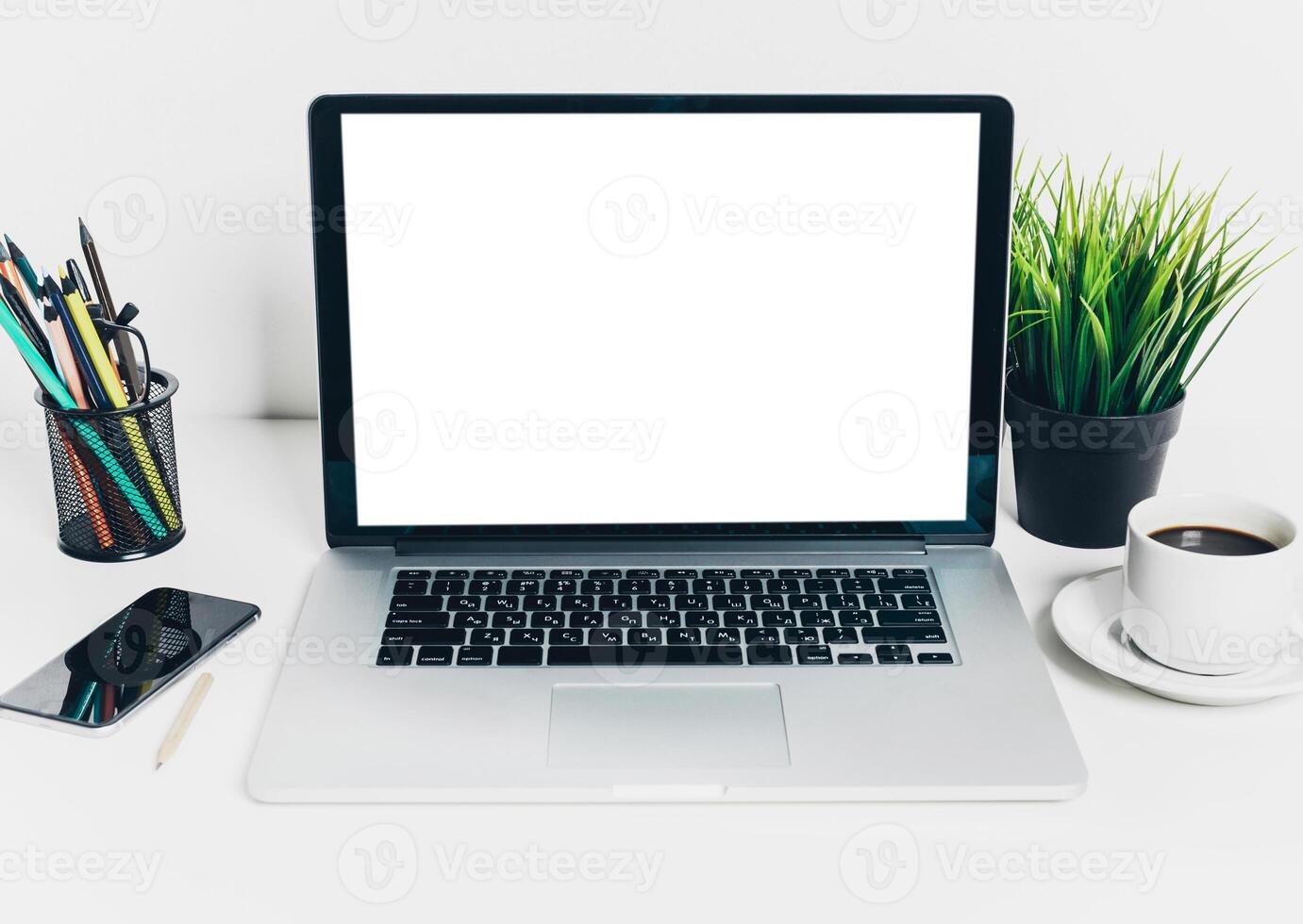 Front view of modern workplace in office with computer and supplies photo