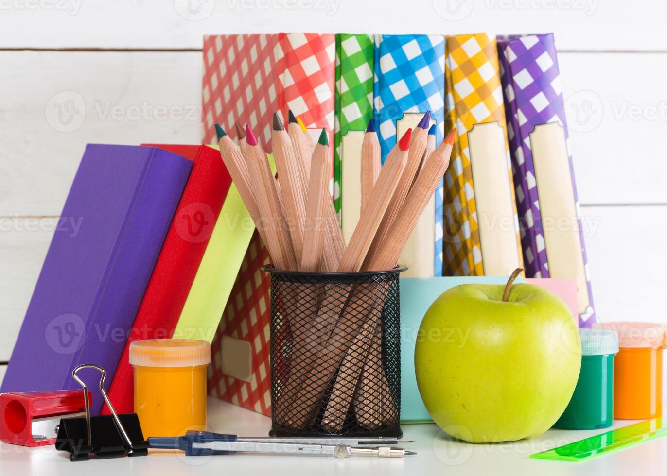 Set of school supplies on white table, front view photo