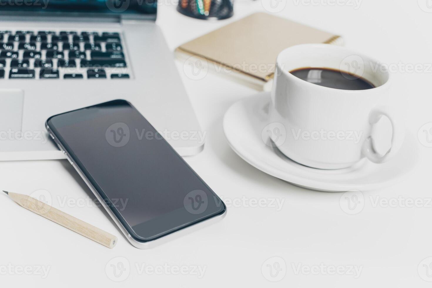 Close up shot of working table with gadget and supplies photo