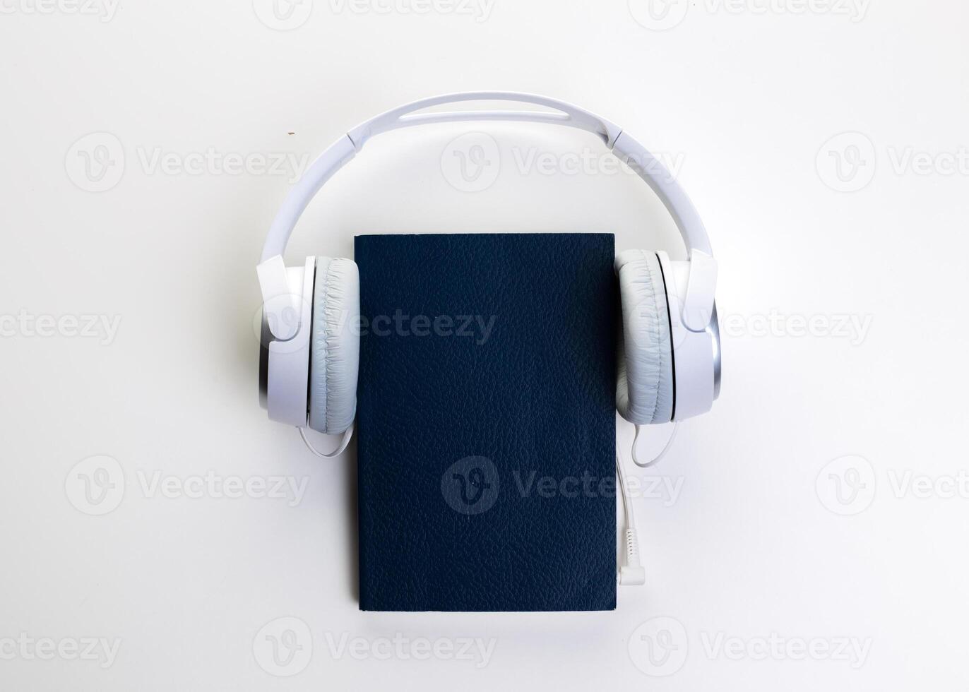 White headphones and notepad on white background photo