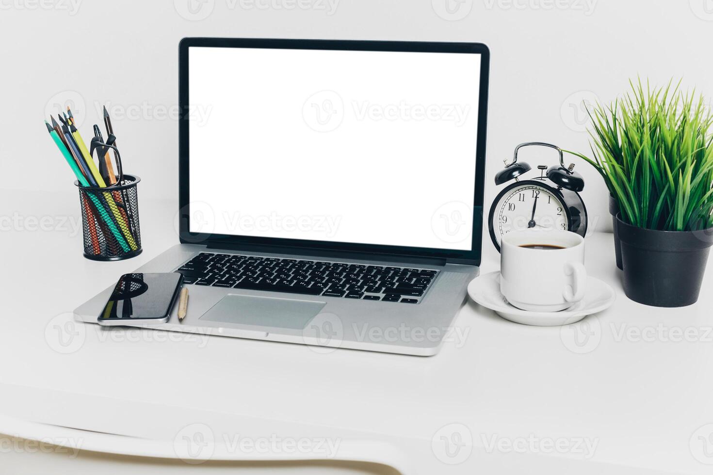 Front view of modern workplace in office with computer and supplies photo