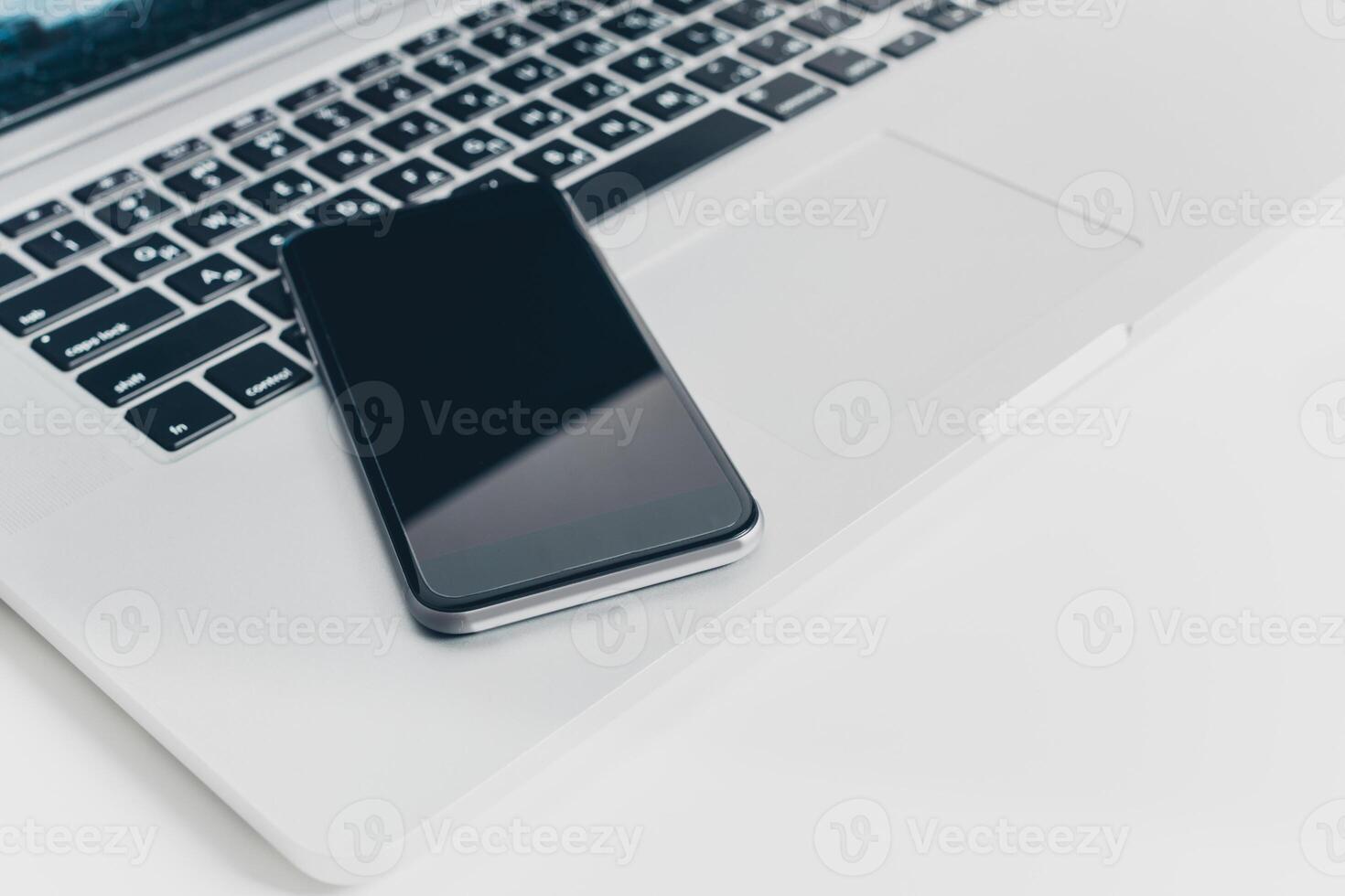 Close up shot of working table with gadget and supplies photo