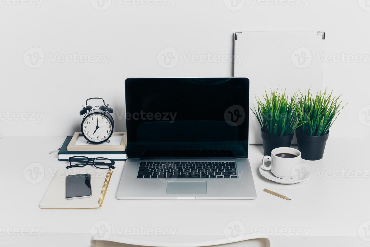 Front view of modern workplace in office with computer and supplies photo