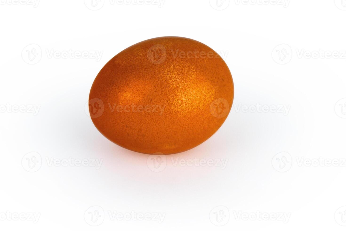 Vibrant orange easter egg with glowing shell pattern, isolated on white background. Color contrast, creativity, holiday decoration, creativity, symbolism of rebirth. Copy space. Selective focus photo