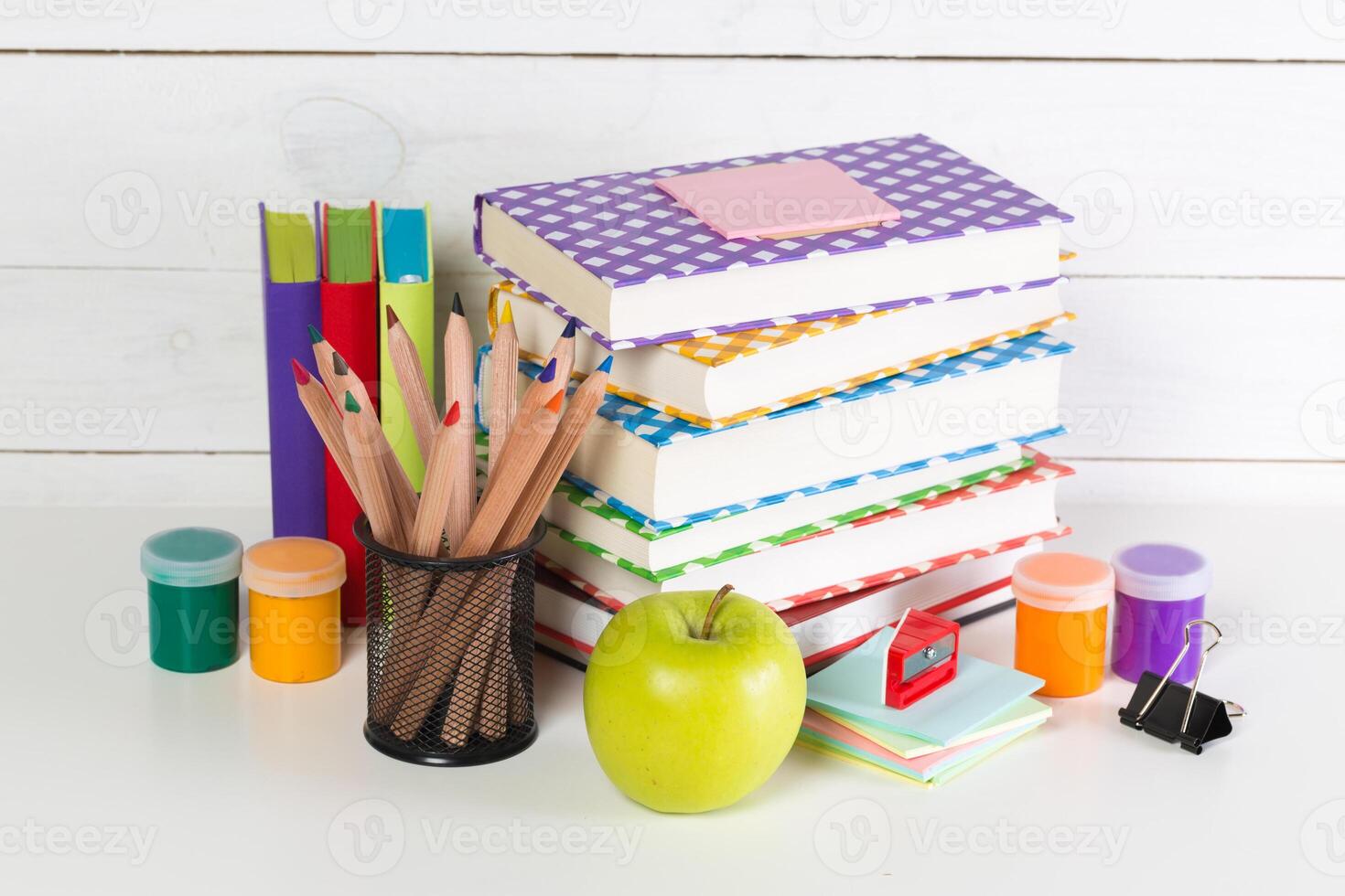 Set of school supplies on white table, front view photo