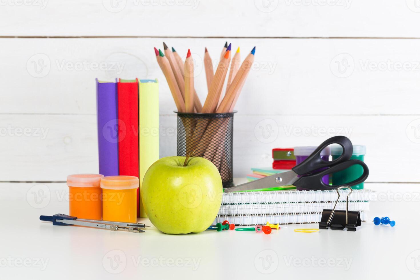 Set of school supplies on white table, front view photo