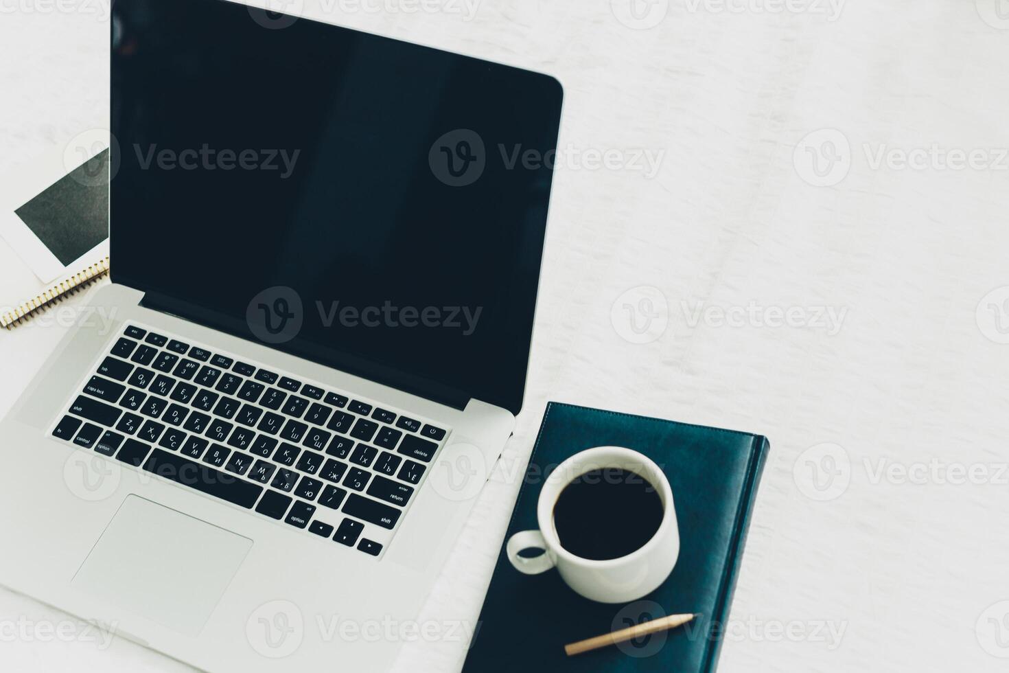 Front view of modern workplace in office with computer and supplies photo