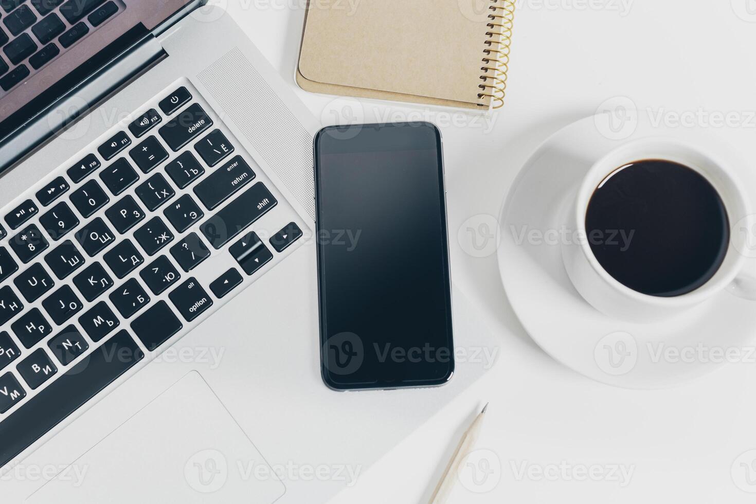 Close up shot of working table with gadget and supplies photo