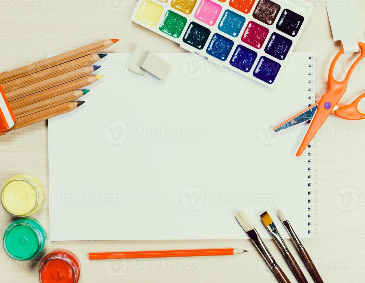 Art supplies arranged on a table ready for a creative project during daylight hours photo