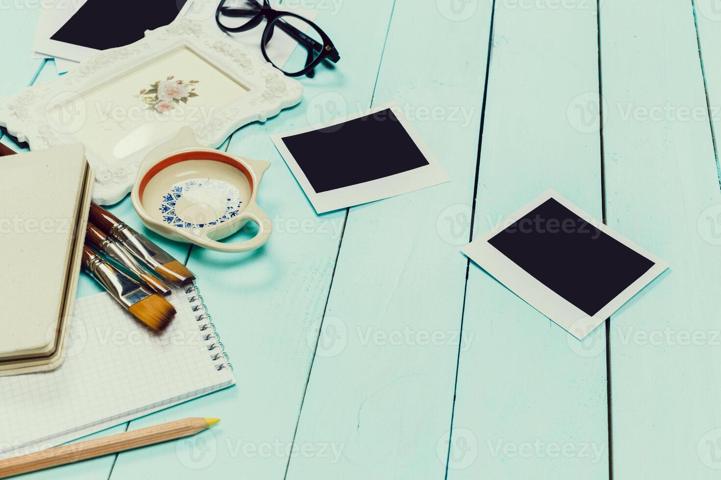 Crafting a nostalgic workspace with personal touches and creative supplies on a light blue wooden table photo
