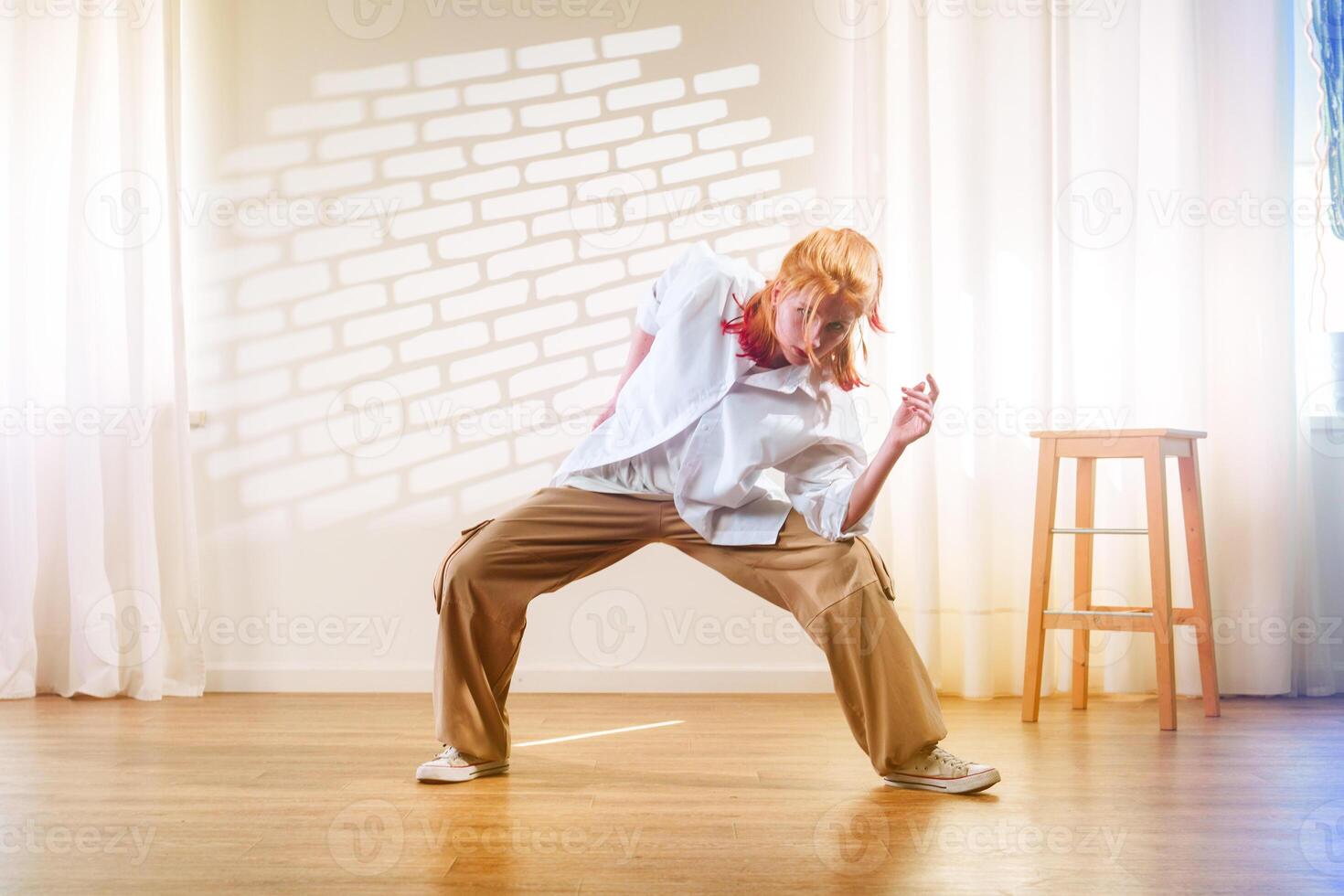 Dynamic dance performance showcasing expressive movement in a studio setting with natural light photo