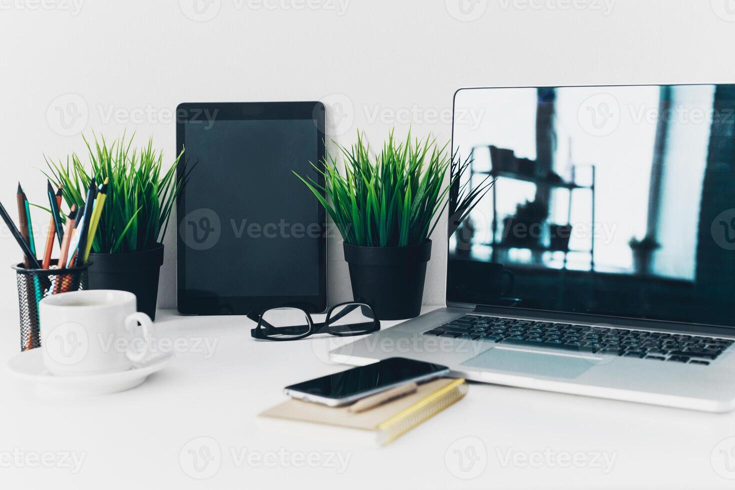 Close up shot of working table with gadget and supplies photo
