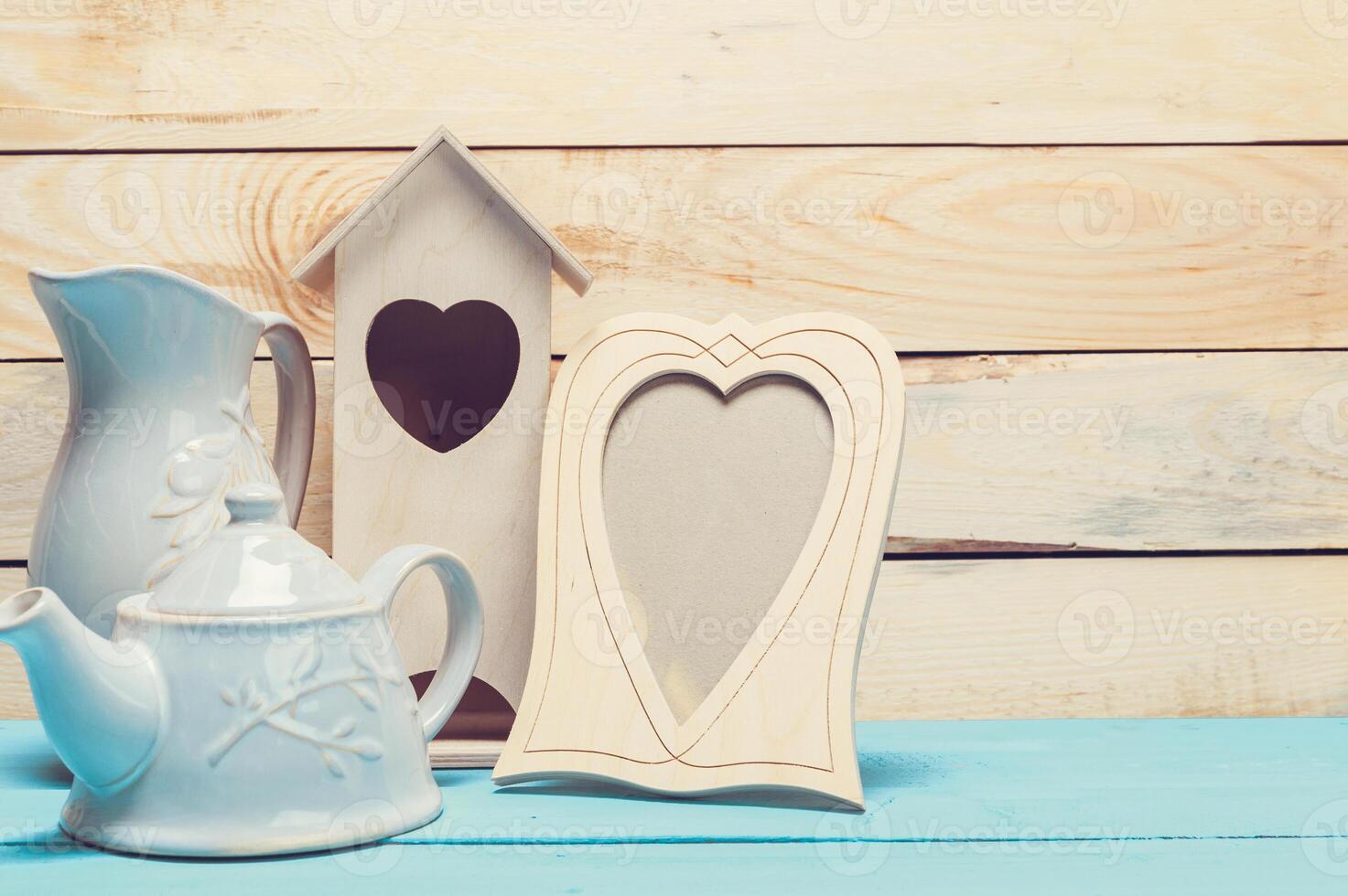 Cozy pastel wooden home decor objects on blue background photo
