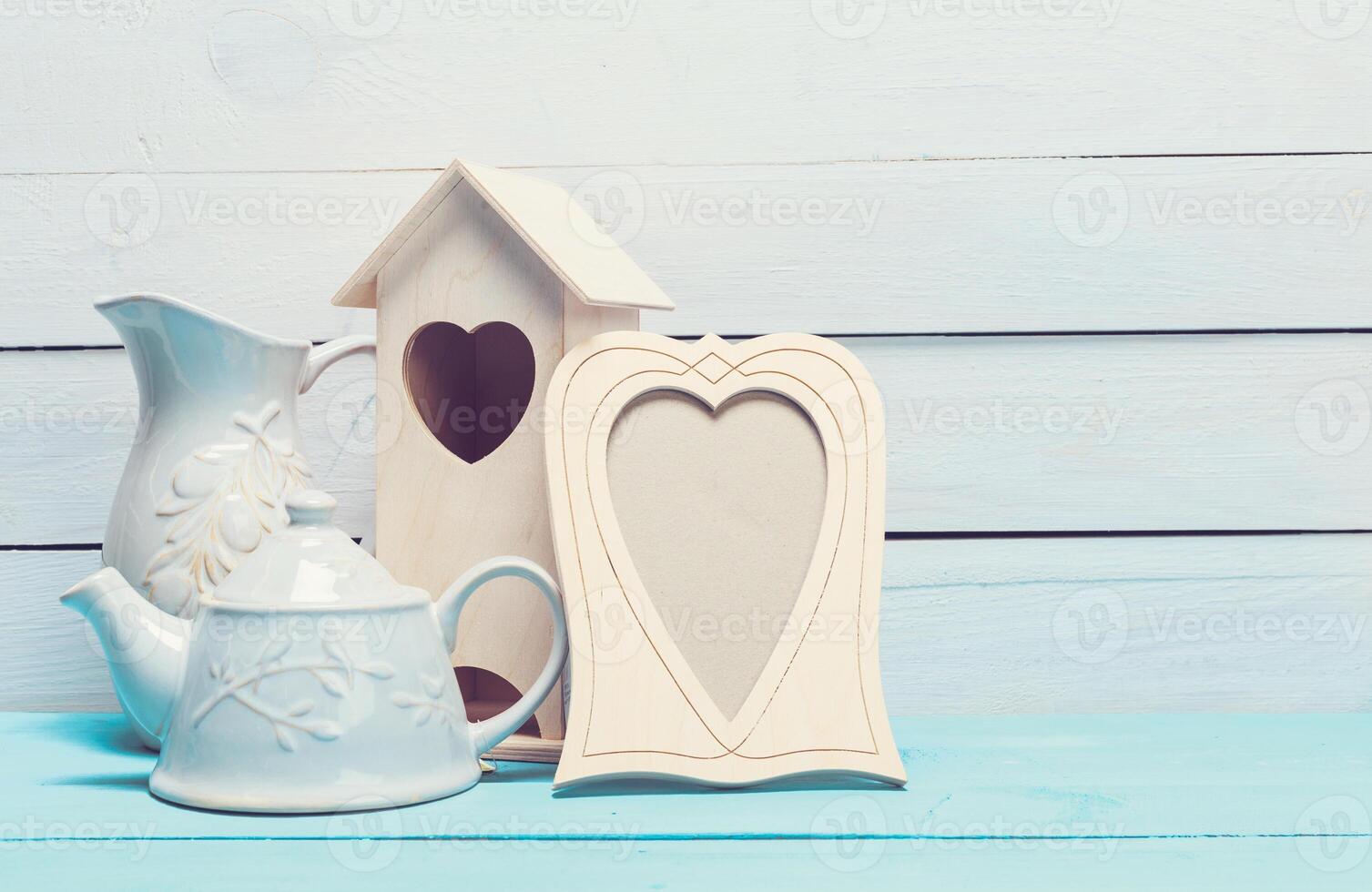 Cozy pastel wooden home decor objects on blue background photo