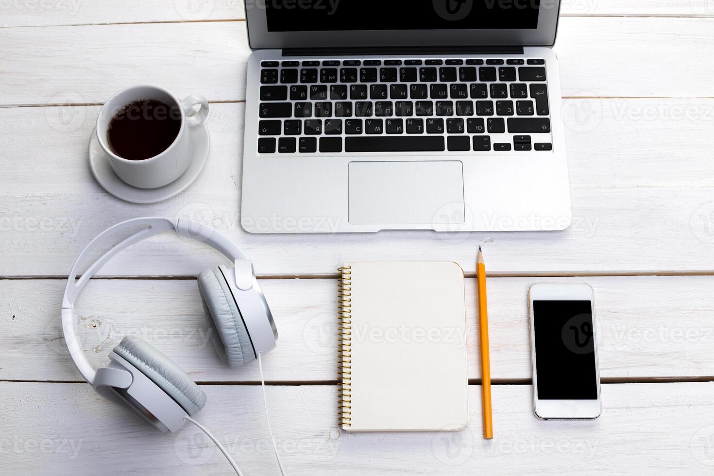 White wooden table with gadgets, view from above photo