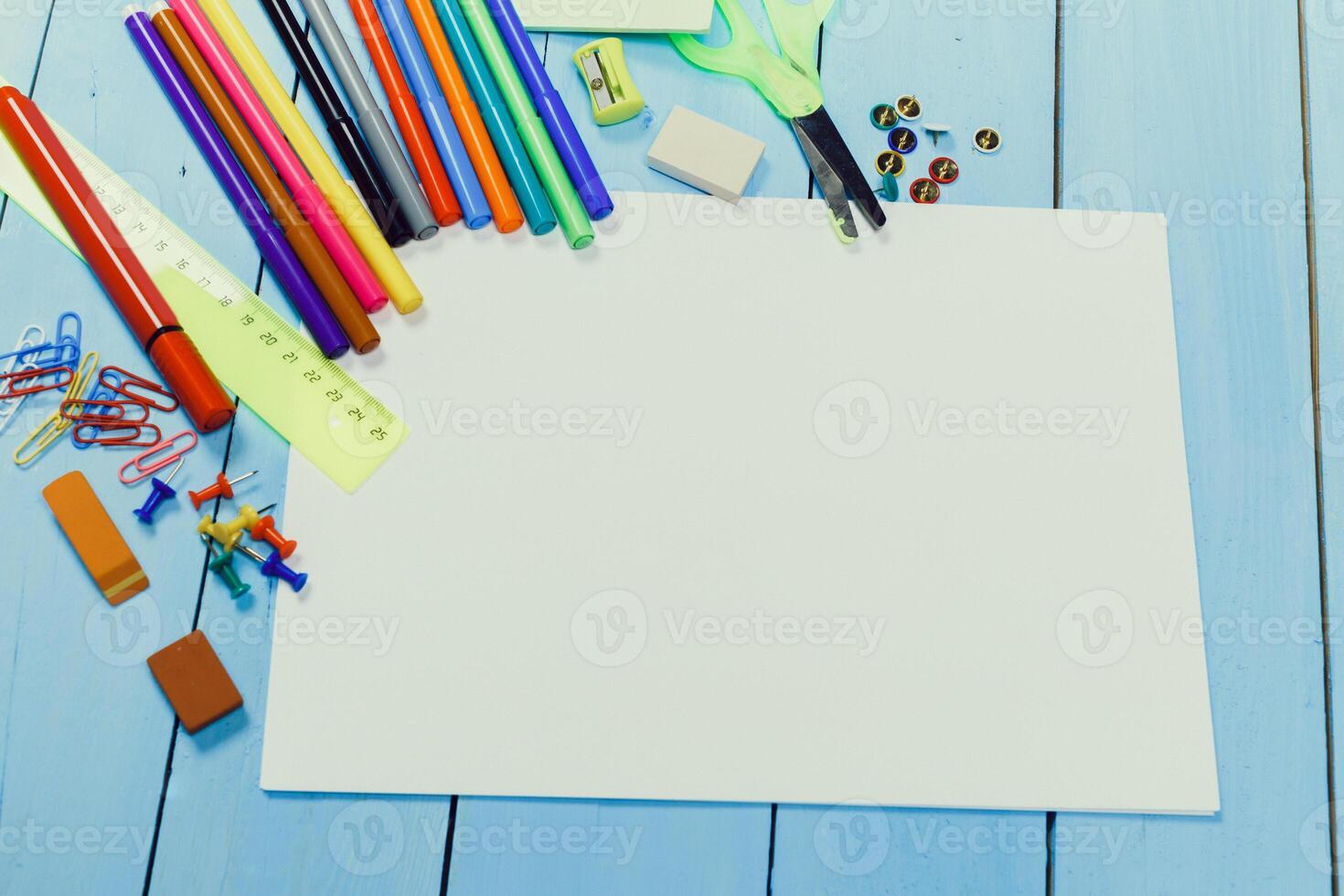 Creative workspace with colorful art supplies on a blue wooden table preparing for a crafting project photo