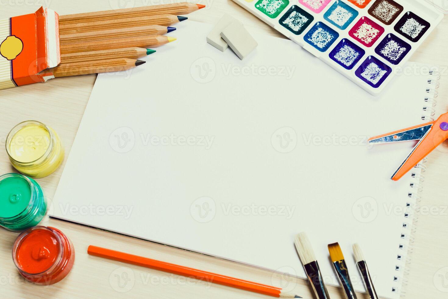 Creative workspace for artists featuring tools, paints, and blank canvas ready for inspiration at a sunny afternoon photo