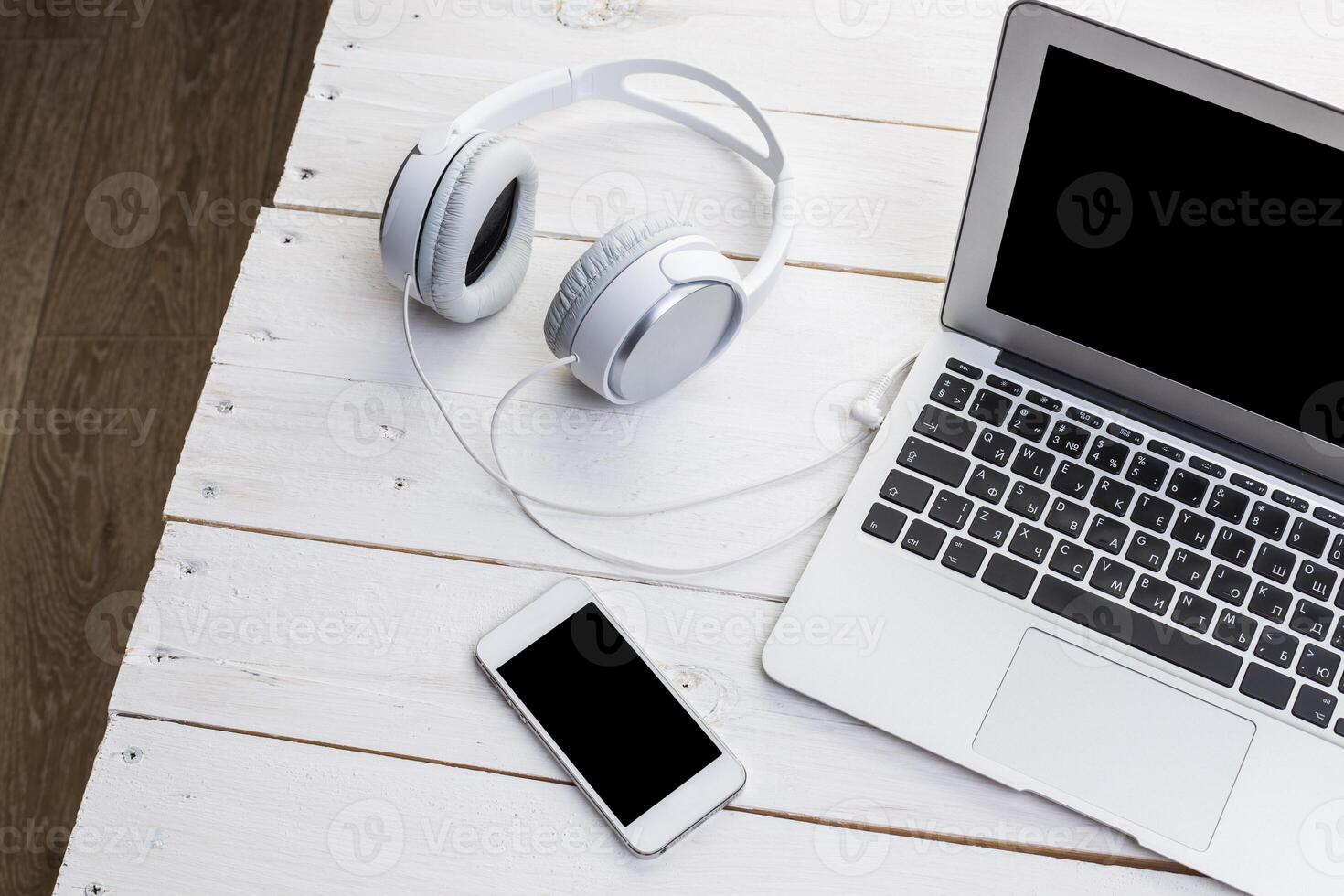White wooden table with gadgets, view from above photo