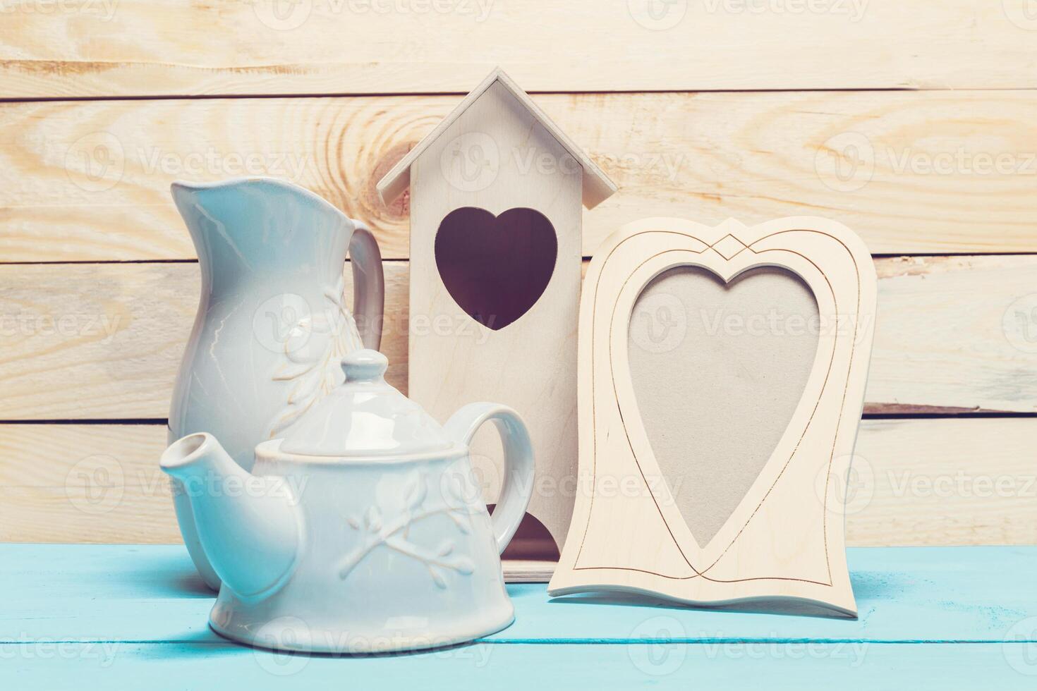 Cozy pastel wooden home decor objects on blue background photo