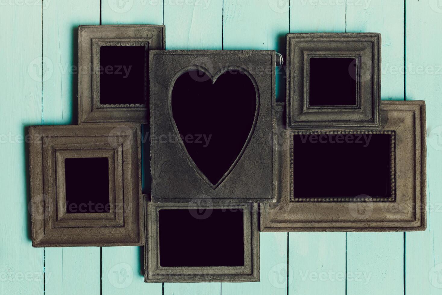 Creative arrangement of empty picture frames on a light blue wooden background for decoration photo