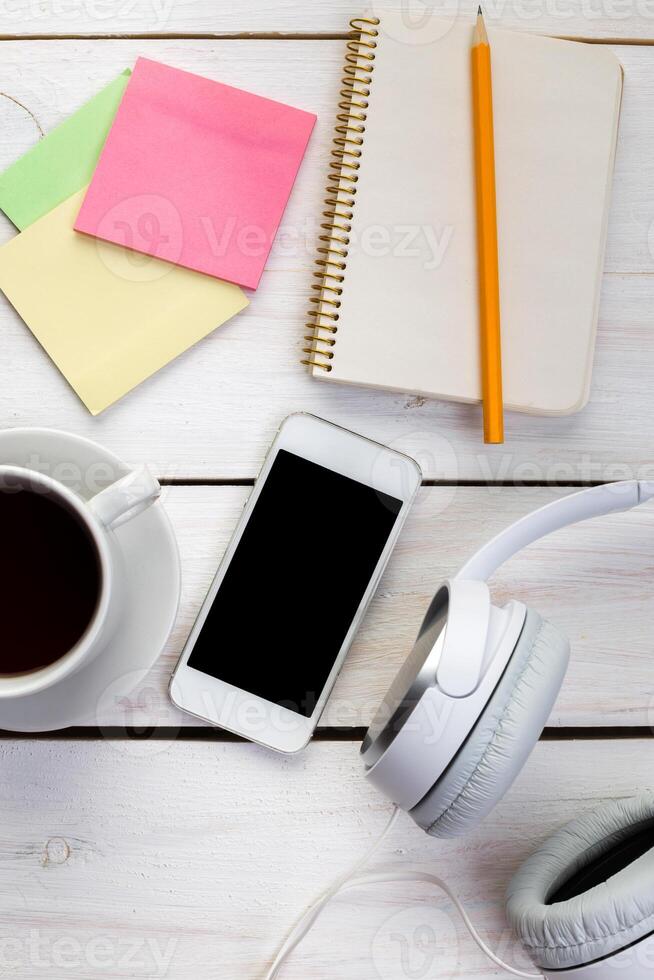 White wooden table with gadgets, view from above photo