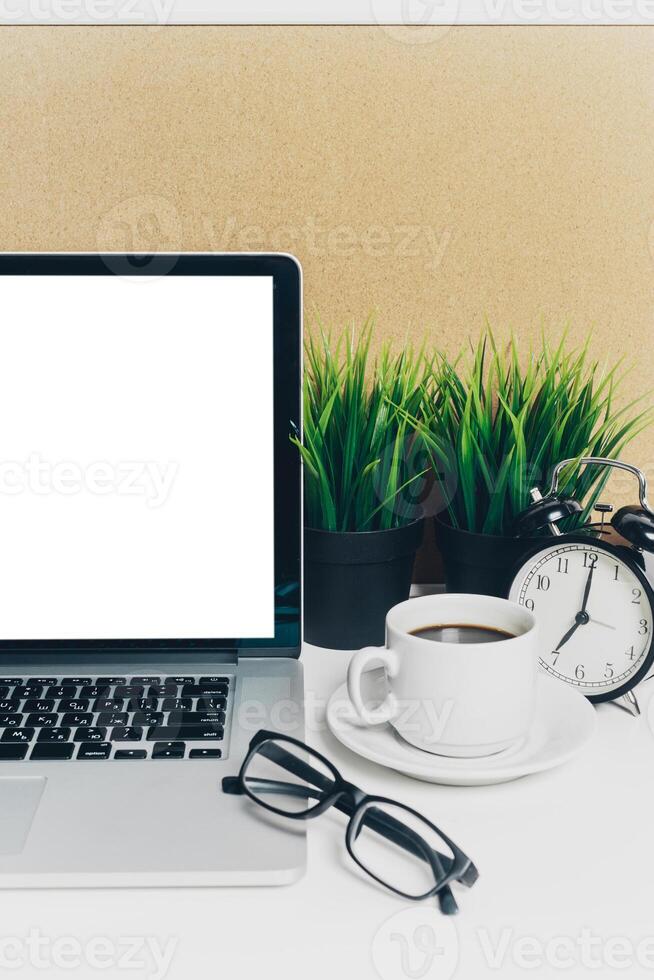 Front view of modern workplace in office with computer and supplies photo