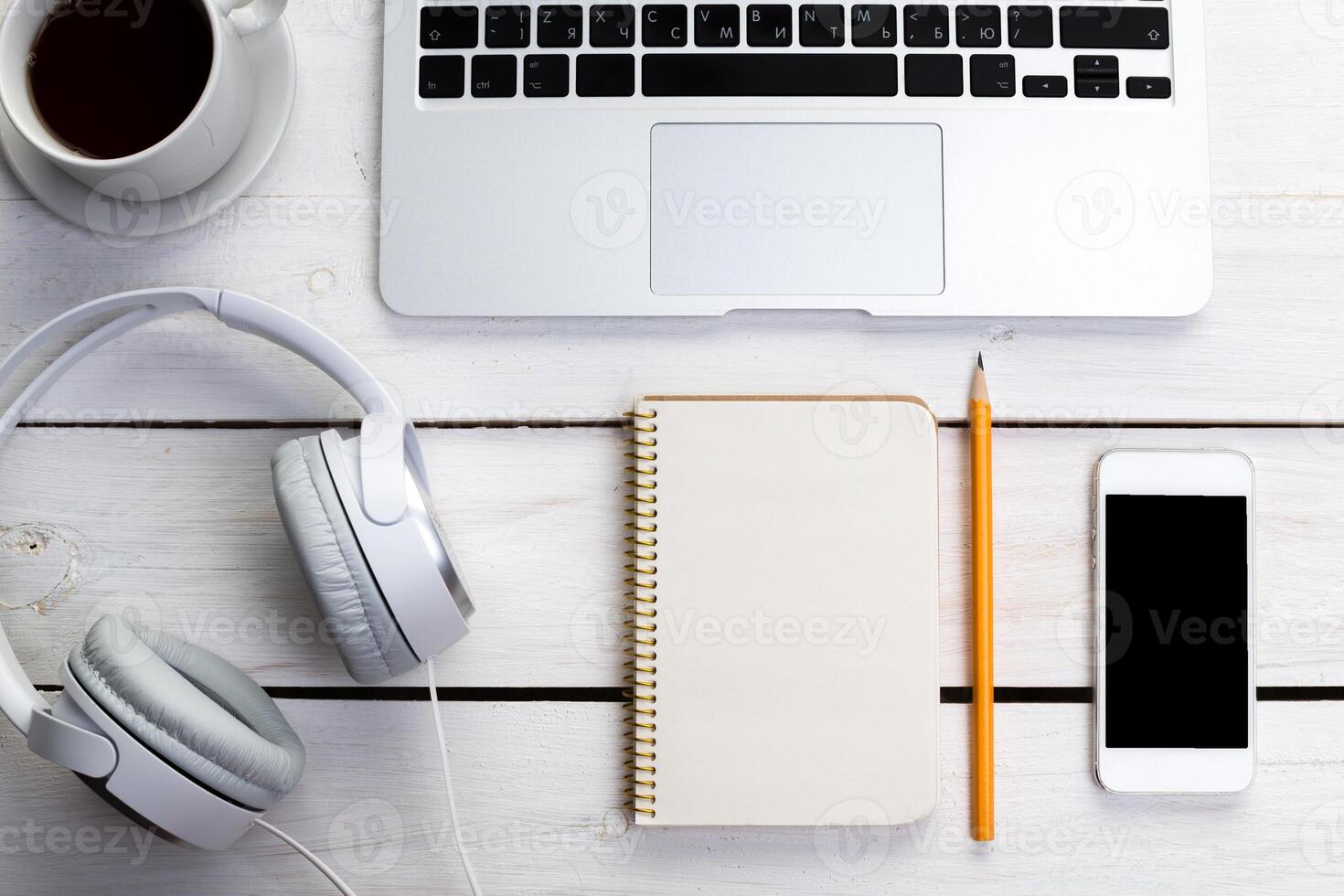 White wooden table with gadgets, view from above photo
