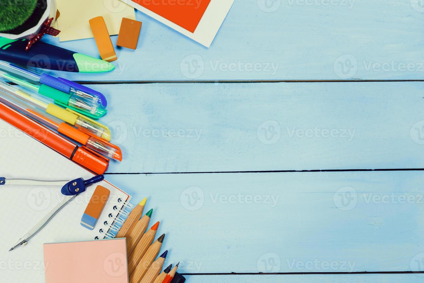 Colorful stationery and school supplies arranged on a light blue wooden table ready for creative work or study tasks photo