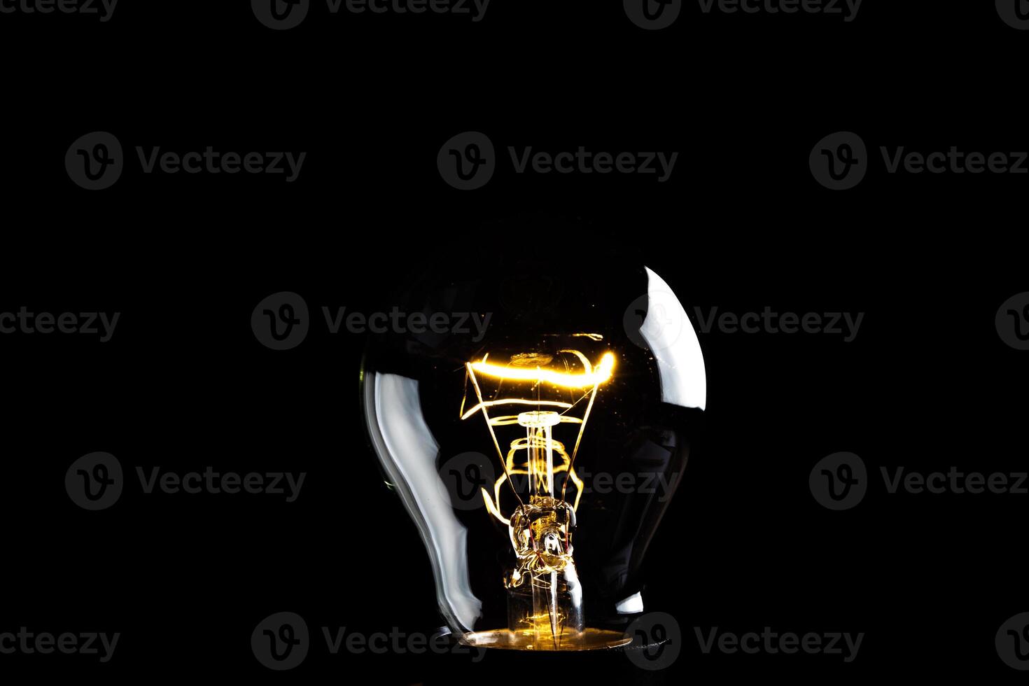 Close-up of electrical bulb on black background photo