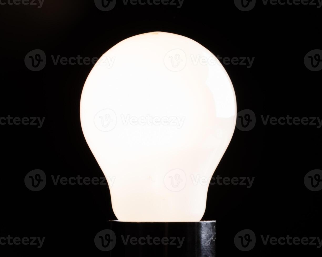 Close-up of electrical bulb on black background photo