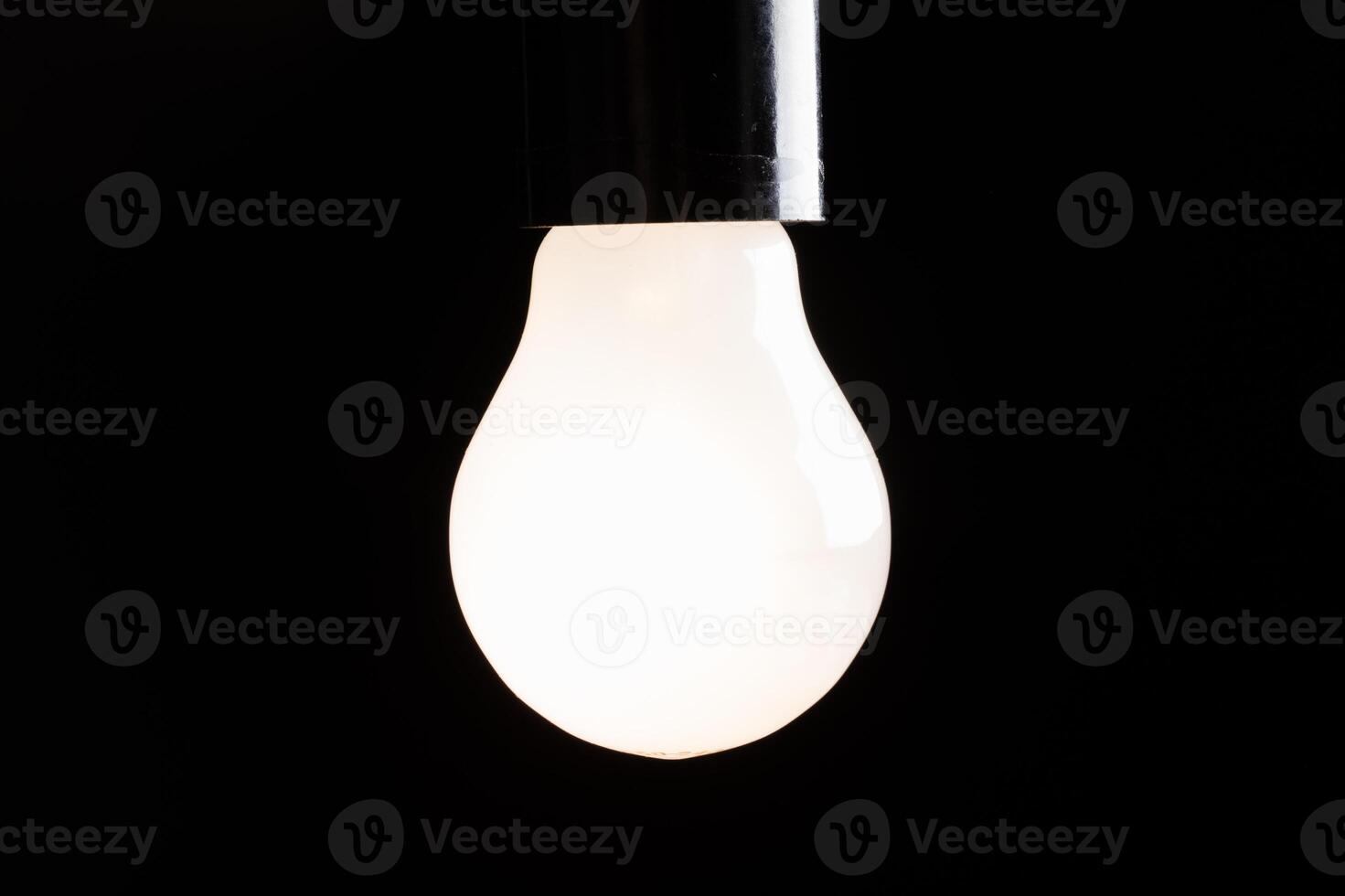 Close-up of electrical bulb on black background photo