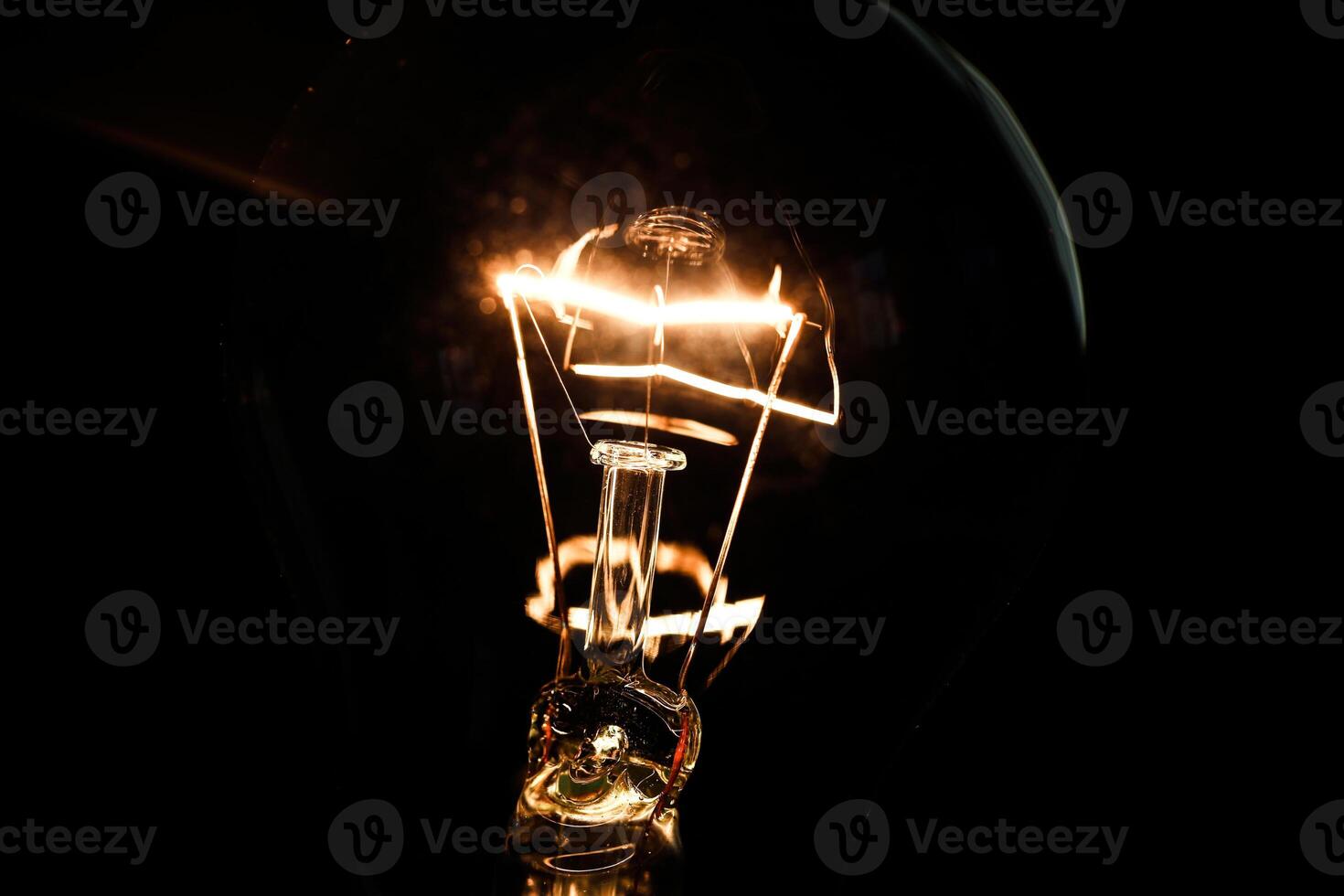 Close-up of electrical bulb on black background photo