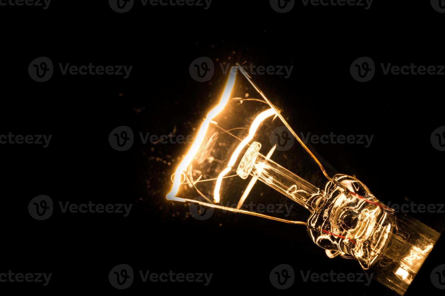 Close-up of electrical bulb on black background photo