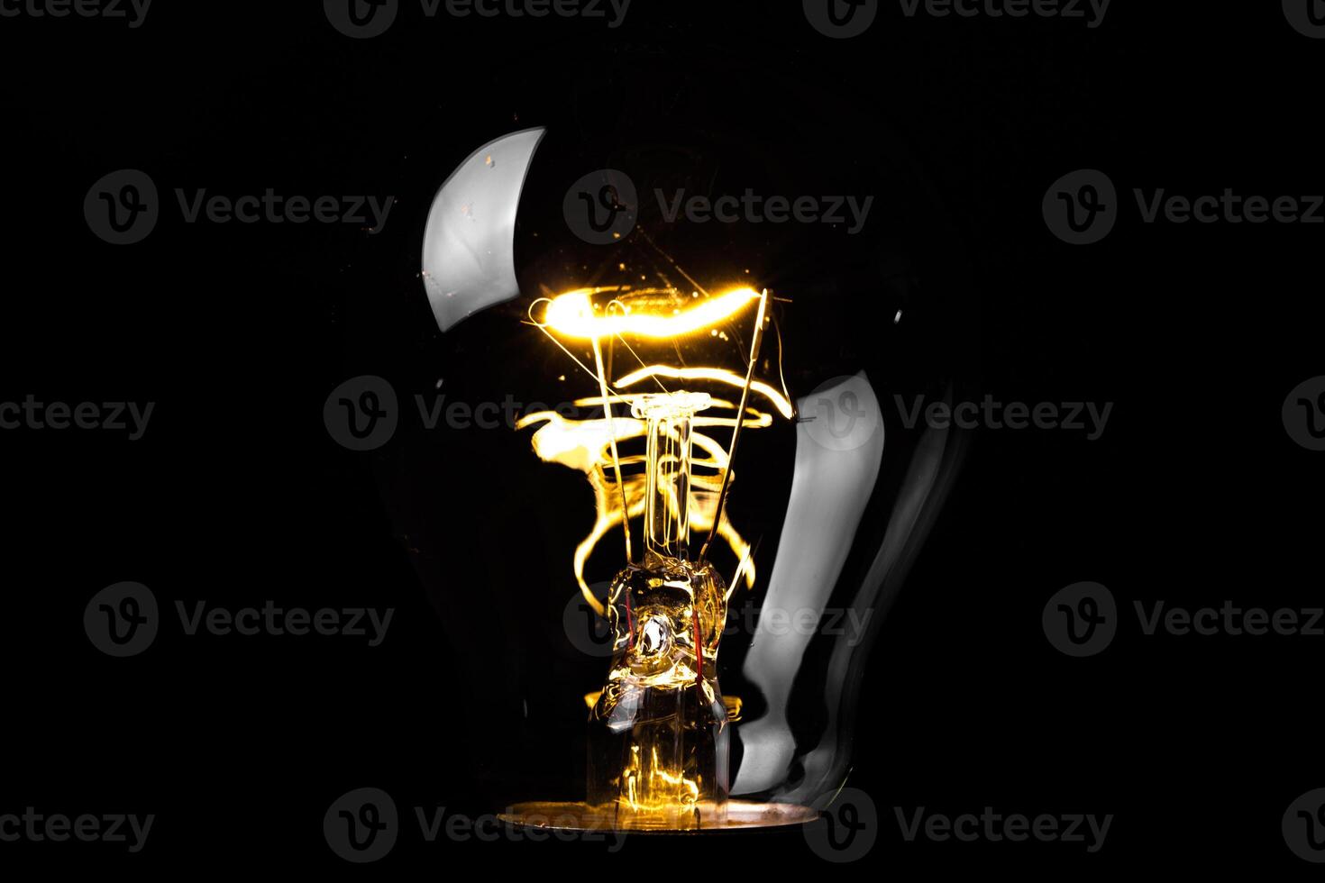 Close-up of electrical bulb on black background photo