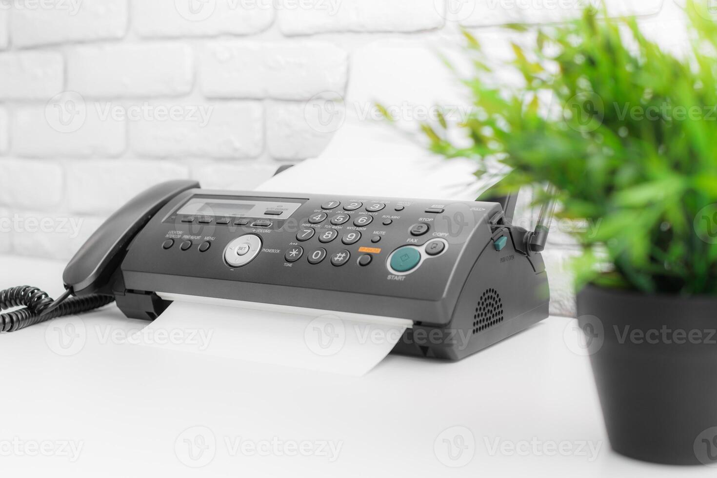 Fax machine, office equipment on white table photo