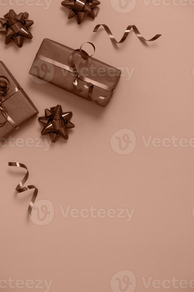 Flat lay Christmas new year gift boxes on mocha mousse colour background top view with copy space photo